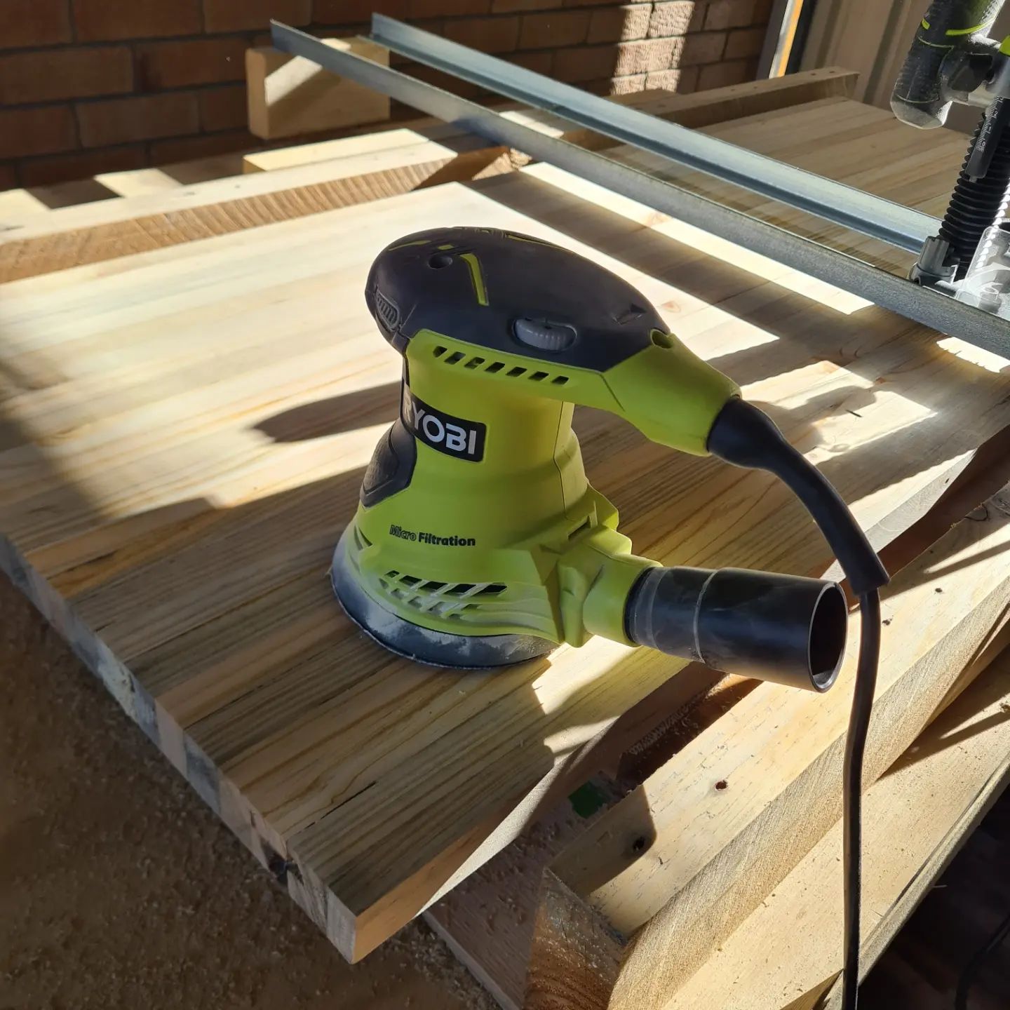 Built a very quick router sled using some 25x25 galv angle screwd to some 2x4 blocks as end stoppers. The base is just 2 pallet rails cleaned up in the thicknesser screwed to some scrap 15mm ply.

Using a half inch plain router bit in the ryobiau 1600w planer made for slow going, but it did do a respectable job considering. First sanding pass done and this pine pallet wood coffee table top is on it's way to being mated to a base (yet to be designed and made)